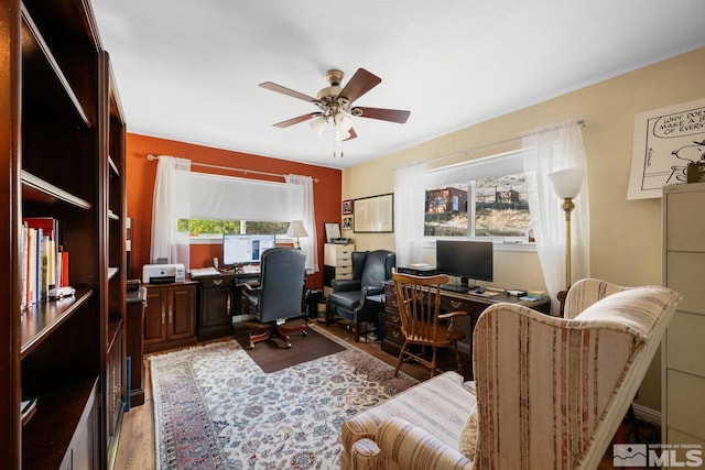 home office with hardwood / wood-style flooring and ceiling fan