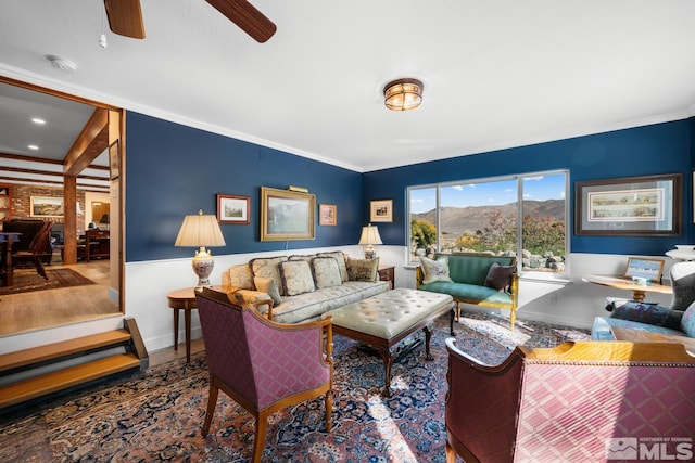 living room featuring a mountain view and crown molding