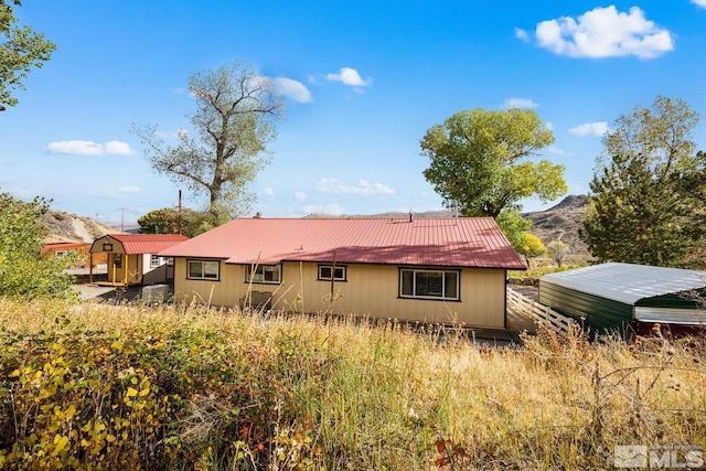 rear view of house featuring a mountain view and a carport