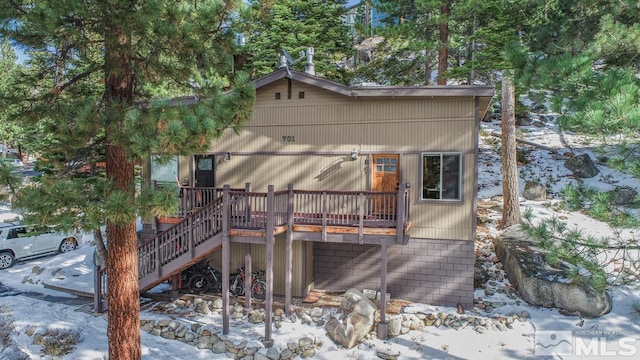 chalet / cabin with a deck and stairs