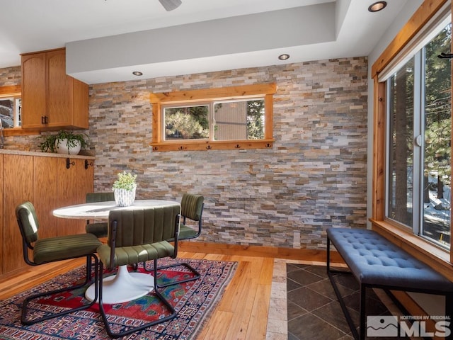 dining space with dark wood-type flooring and a healthy amount of sunlight