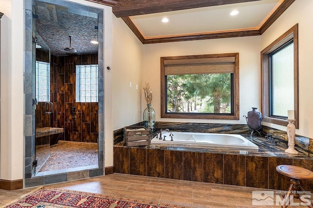 bathroom featuring wood-type flooring, separate shower and tub, and crown molding