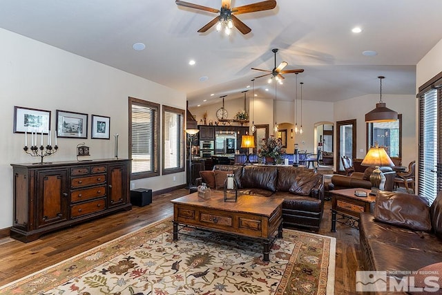 living room featuring ceiling fan, wood-type flooring, and lofted ceiling