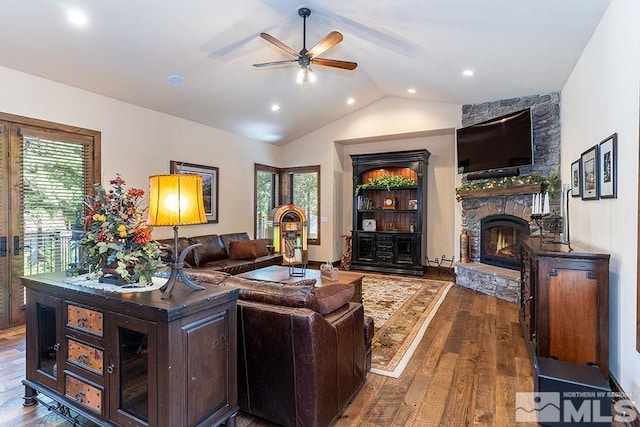 living room featuring a fireplace, wood-type flooring, ceiling fan, and lofted ceiling