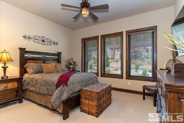 bedroom featuring ceiling fan and light carpet