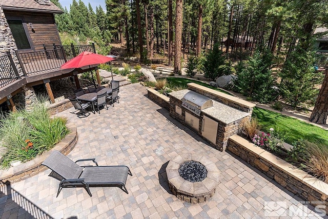 view of patio / terrace featuring area for grilling, grilling area, and a fire pit