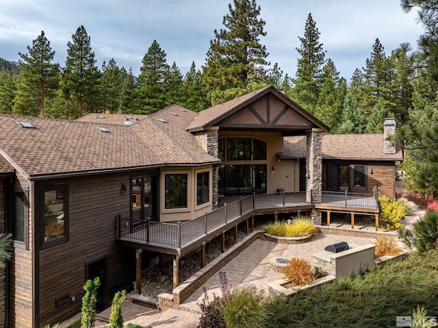 rear view of house featuring a patio and a deck