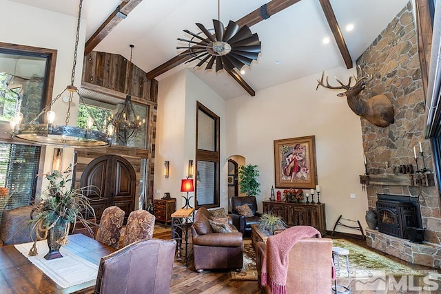 living room with beamed ceiling, plenty of natural light, hardwood / wood-style floors, and high vaulted ceiling