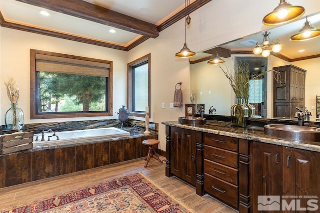 bathroom with hardwood / wood-style floors, a healthy amount of sunlight, and crown molding