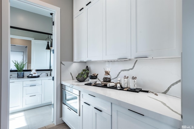 kitchen featuring white cabinetry and light tile patterned flooring