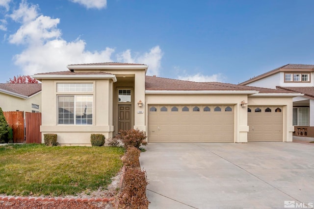 view of front of property featuring a front yard and a garage