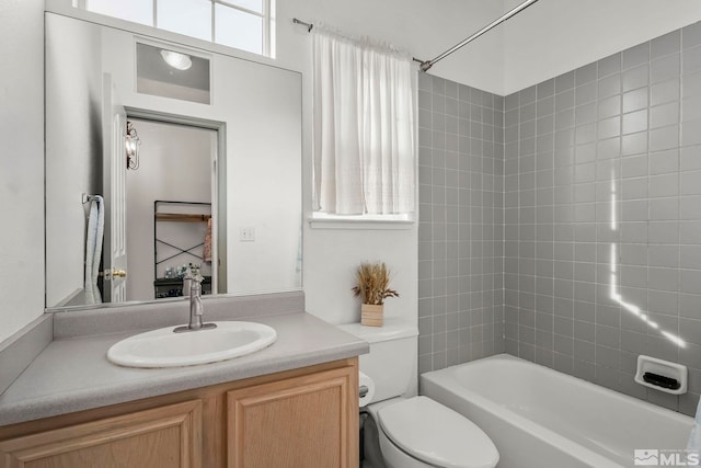 full bathroom featuring vanity, toilet, and tiled shower / bath