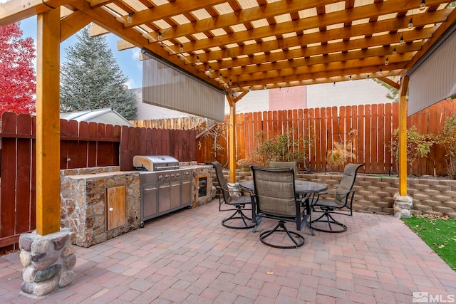 view of patio / terrace featuring an outdoor kitchen, area for grilling, and a pergola