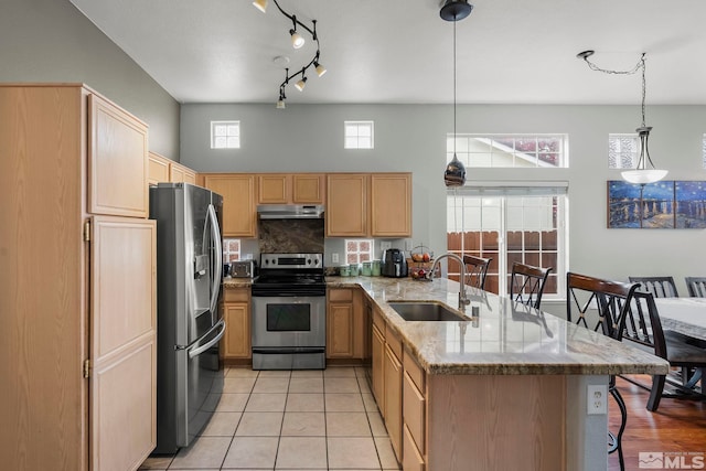 kitchen featuring a kitchen breakfast bar, sink, hanging light fixtures, kitchen peninsula, and stainless steel appliances