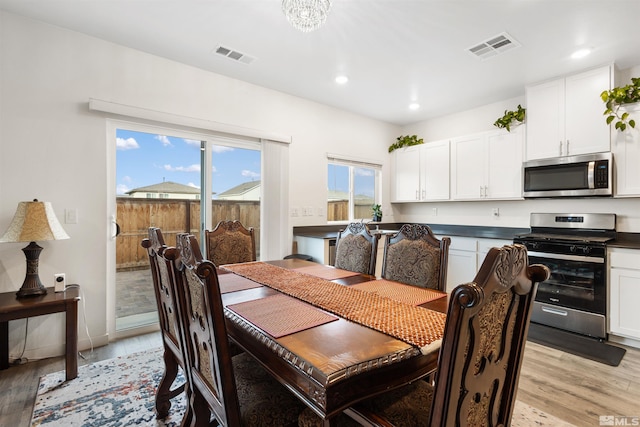 dining space with light wood-type flooring