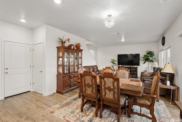 dining room featuring a notable chandelier and light hardwood / wood-style floors