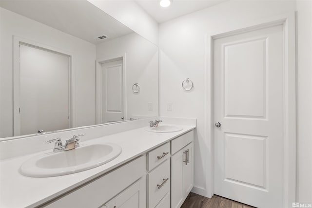 bathroom with hardwood / wood-style flooring and vanity