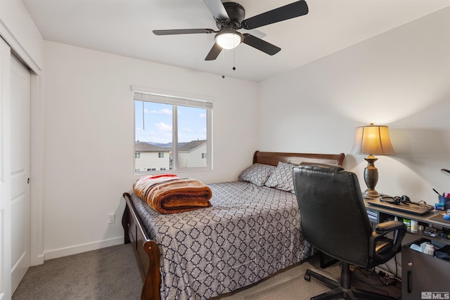 bedroom featuring dark colored carpet, ceiling fan, and a closet