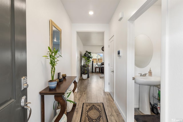 corridor featuring hardwood / wood-style floors and sink