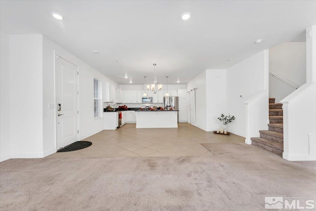 unfurnished living room featuring light carpet