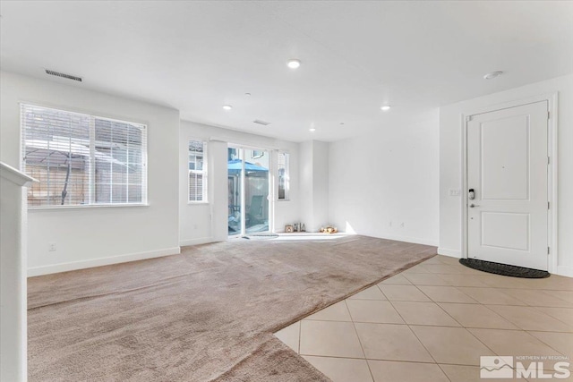 unfurnished living room with light colored carpet