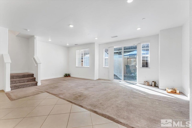 unfurnished living room featuring light carpet