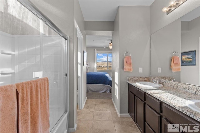 bathroom featuring tile patterned flooring, vanity, ceiling fan, and enclosed tub / shower combo