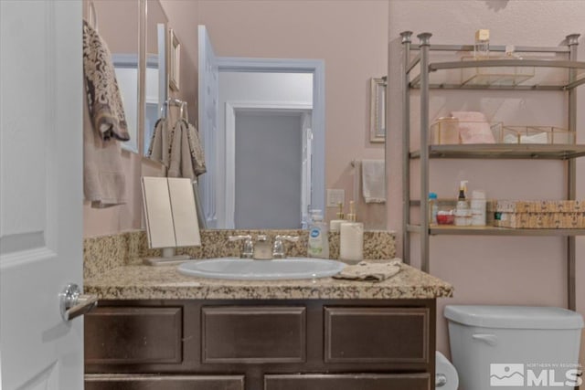 bathroom with vanity and toilet