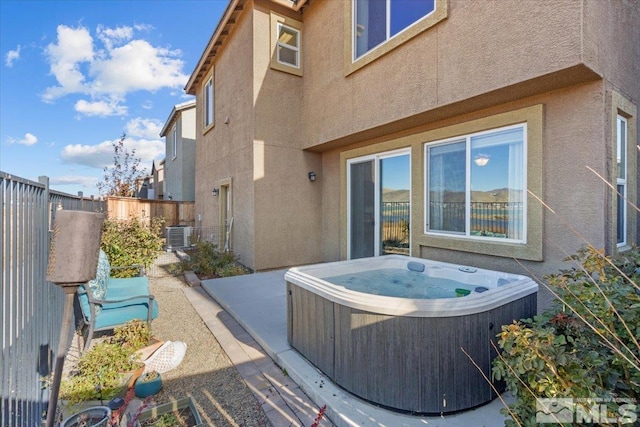 view of patio featuring a hot tub and central AC unit