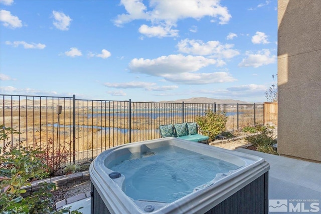 view of yard with a water view and a hot tub