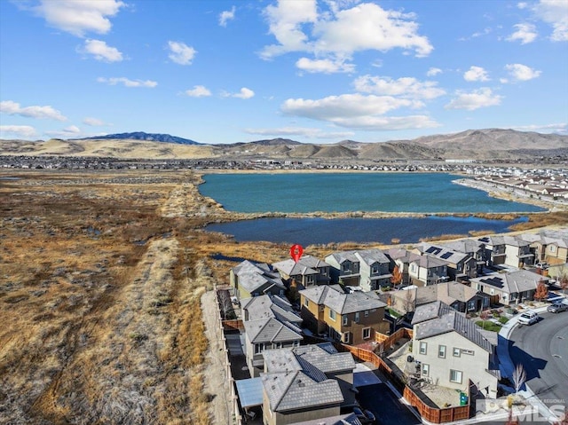 bird's eye view with a water and mountain view