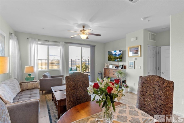 tiled dining space featuring ceiling fan