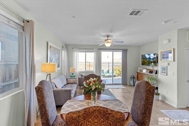 dining area featuring ceiling fan and light tile patterned floors