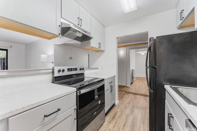 kitchen with white cabinets, light wood-type flooring, and stainless steel appliances