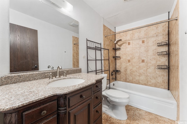 full bathroom featuring tile patterned flooring, toilet, vanity, and tiled shower / bath