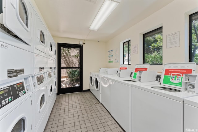 washroom with washing machine and dryer, light tile patterned floors, and stacked washer and dryer