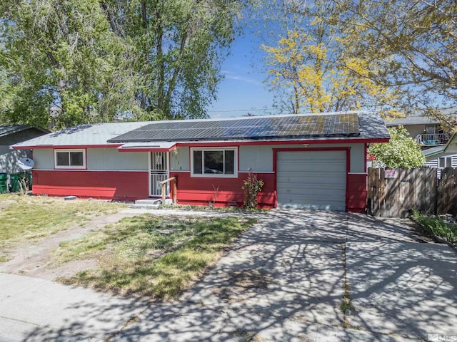 ranch-style house featuring solar panels and a garage