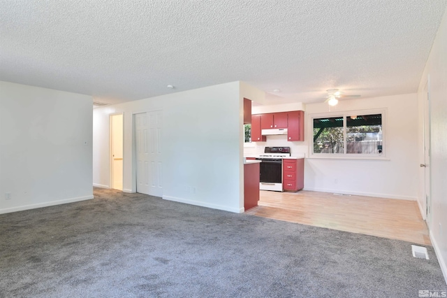 unfurnished living room with hardwood / wood-style floors, a textured ceiling, and ceiling fan