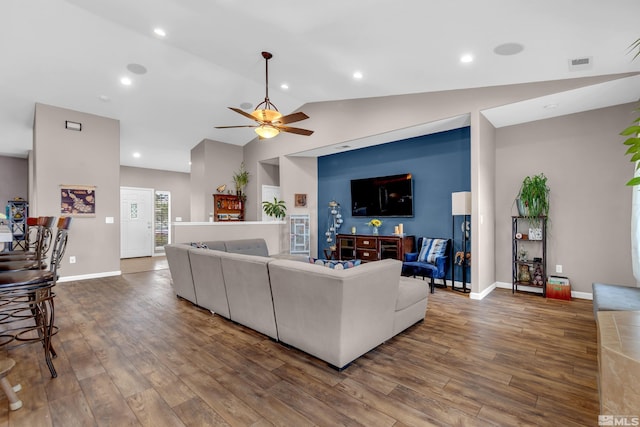 living room featuring hardwood / wood-style floors, vaulted ceiling, and ceiling fan