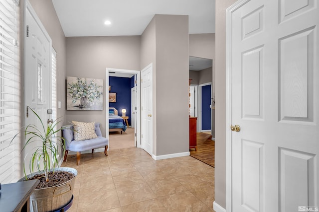 corridor featuring light hardwood / wood-style floors and vaulted ceiling