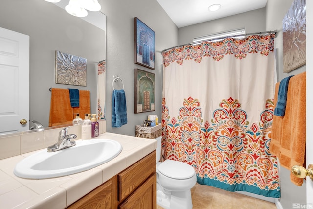 bathroom featuring tile patterned floors, vanity, and toilet