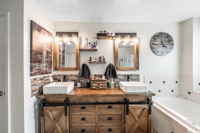 bathroom featuring tiled bath and vanity