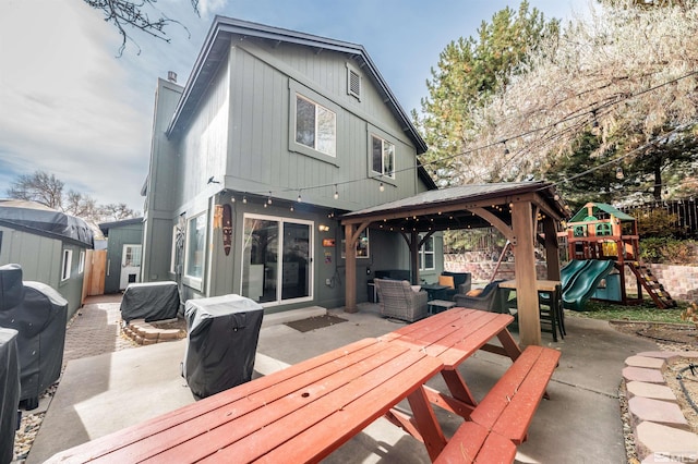 back of property with an outdoor hangout area, a playground, and a patio