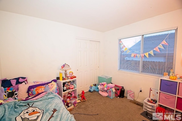 carpeted bedroom featuring a closet