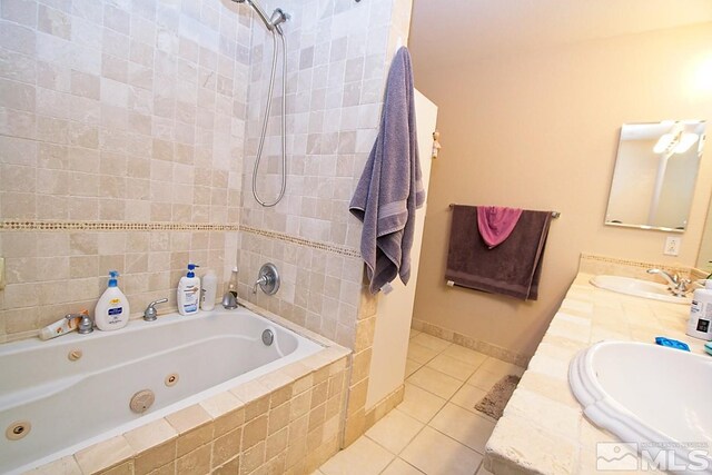 bathroom with vanity, tiled shower / bath combo, and tile patterned flooring