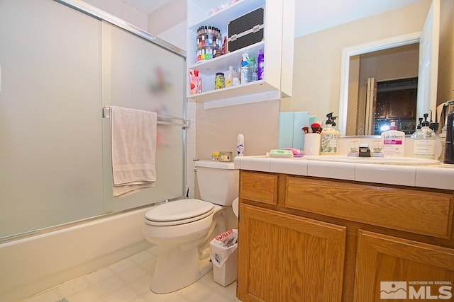 full bathroom with bath / shower combo with glass door, vanity, and toilet