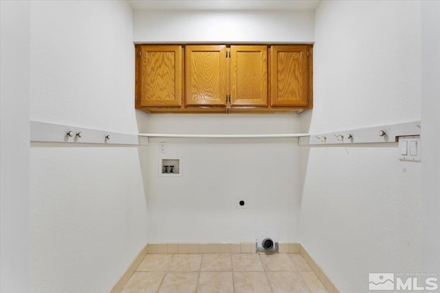 laundry room featuring washer hookup, light tile patterned flooring, cabinets, and hookup for an electric dryer