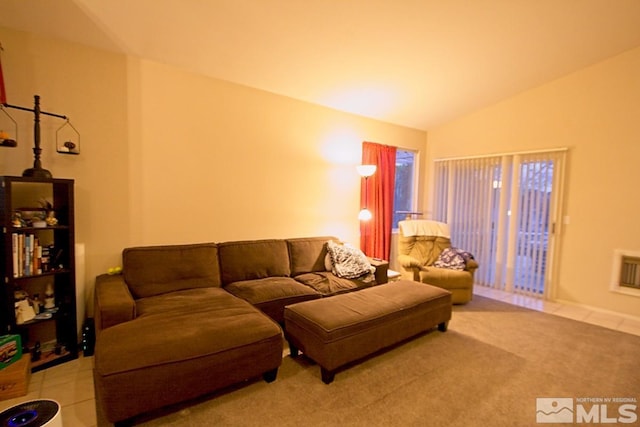 living room featuring light tile patterned flooring, lofted ceiling, and heating unit