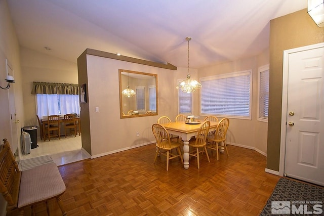 dining room with an inviting chandelier, vaulted ceiling, and parquet flooring