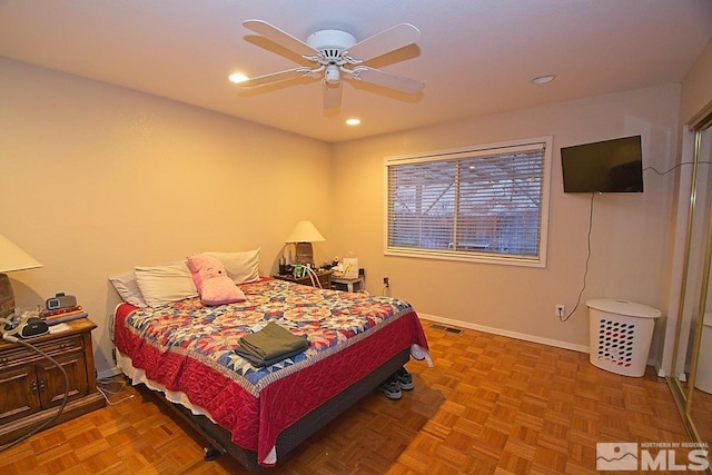 bedroom with parquet floors and ceiling fan